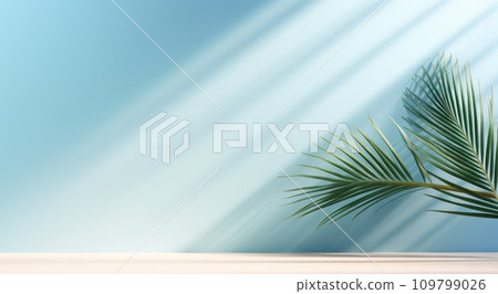 a palm leaf in front of a blue wall a palm leaf in front of a blue wall 109799026