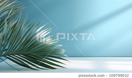 a palm leaf in front of a blue wall a palm leaf in front of a blue wall 109799032