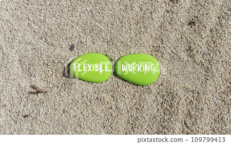 Flexible working symbol. Concept words Flexible working on beautiful green stone. Beautiful sand beach background. Business flexible working concept. Copy space. 109799413