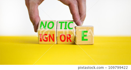 Notice or ignore symbol. Concept word Notice or Ignore on wooden cubes. Beautiful yellow table white background. Businessman hand. Business lifestyle and notice or ignore concept. Copy space. Notice or ignore symbol. Concept word Notice or Ignore on wooden cubes. Beautiful yellow table white background. Businessman hand. Business lifestyle and notice or ignore concept. Copy space. 109799422