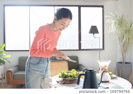 A woman making a salad A woman making a salad 109799768