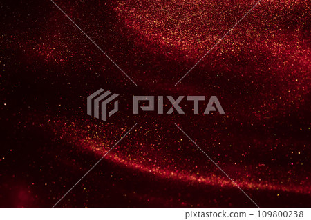 Glittering flows of gold particles in fluid. 109800238