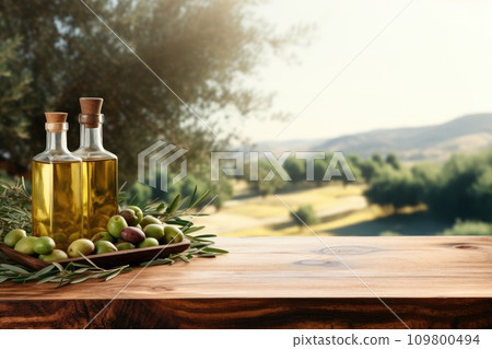 Old wooden product display table with natural green olive field and olive oil 109800494