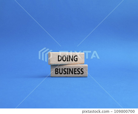 Doing Business symbol. Concept word Doing Business on wooden blocks. Beautiful blue background. Business and Doing Business concept. Copy space Doing Business symbol. Concept word Doing Business on wooden blocks. Beautiful blue background. Business and Doing Business concept. Copy space 109800700