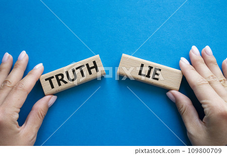 Truth or Lie symbol. Concept word Truth or Lie on wooden blocks. Businessman hand. Beautiful blue background. Business and Truth or Lie concept. Copy space Truth or Lie symbol. Concept word Truth or Lie on wooden blocks. Businessman hand. Beautiful blue background. Business and Truth or Lie concept. Copy space 109800709
