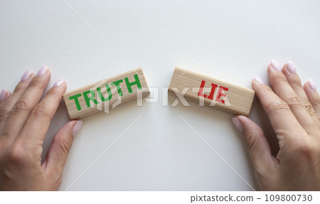 Truth or Lie symbol. Concept word Truth or Lie on wooden blocks. Businessman hand. Beautiful white background. Business and Truth or Lie concept. Copy space Truth or Lie symbol. Concept word Truth or Lie on wooden blocks. Businessman hand. Beautiful white background. Business and Truth or Lie concept. Copy space 109800730