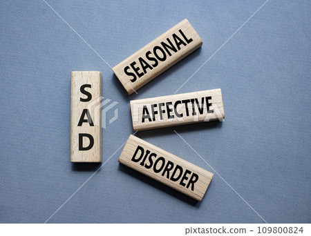 Sad - Seasonal Affective Disorder symbol. Wooden blocks with words Sad. Beautiful grey background. Business and Sad concept. Copy space. 109800824