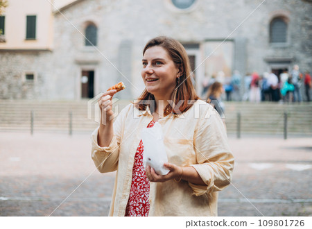 Happy woman holding Sicilian cannolo tube pastry filled with cream. Travel, Italy and holidays concept. Young women eating traditional delicious cake cannoli, Traveling Europe in summer Happy woman holding Sicilian cannolo tube pastry filled with cream. Travel, Italy and holidays concept. Young women eating traditional delicious cake cannoli, Traveling Europe in summer 109801726