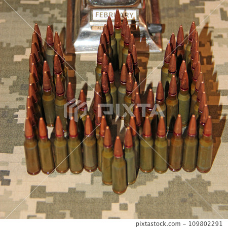 Cartridges for the Kalashnikov assault rifle. War Concept. Ukrainian symbol 109802291
