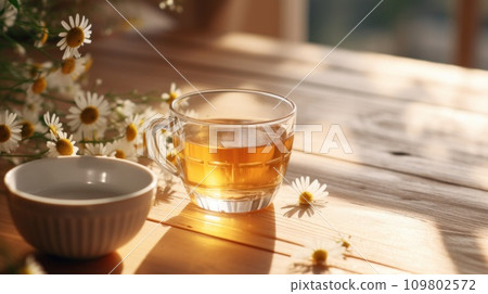 tea with chamomile on a wooden table 109802572