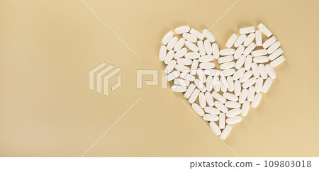 The heart is lined with white headache pills. The concept of medicine and pharmaceuticals. 109803018