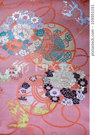 Against the backdrop of drums, flowers, and a lion obi Against the backdrop of drums, flowers, and a lion obi 109803281