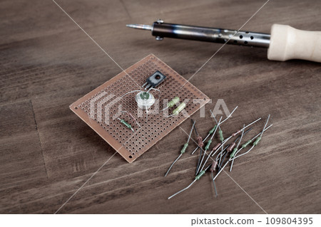 DIY. Do it yourself. Workplace with soldering iron, tools and electronic components background DIY. Do it yourself. Workplace with soldering iron, tools and electronic components background 109804395
