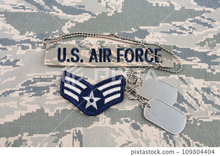 August 31, 2020. US AIR FORCE branch tape and Senior Airman rank patch and dog tags on digital tiger-stripe pattern Airman Battle Uniform (ABU) August 31, 2020. US AIR FORCE branch tape and Senior Airman rank patch and dog tags on digital tiger-stripe pattern Airman Battle Uniform (ABU) 109804404