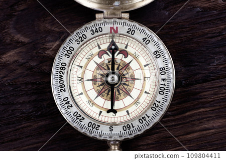 Vintage retro compass on wooden background 109804411