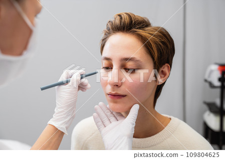 A young woman consults a beautician about her face. 109804625