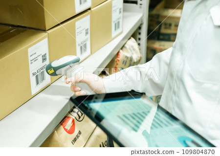 Young woman managing inventory while scanning Faceless Young woman managing inventory while scanning Faceless 109804870
