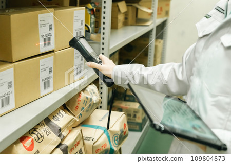 Young woman managing inventory while scanning Faceless 109804873