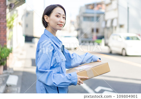 Female delivery member carrying baggage Female delivery member carrying baggage 109804901