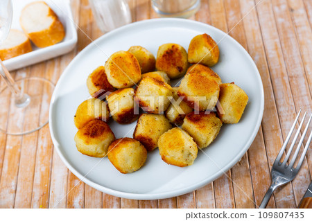 Classic French breaded and deep-fried cheese croquettes on plate Classic French breaded and deep-fried cheese croquettes on plate 109807435