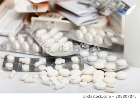 Many different pills and medical capsules close up 109807875