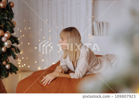 Woman with gift on bed at Christmas Woman with gift on bed at Christmas 109807923