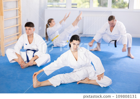 Group of people doing stretching in studio 109808131