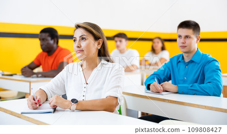Portrait of focused female studying in classroom with colleagues 109808427