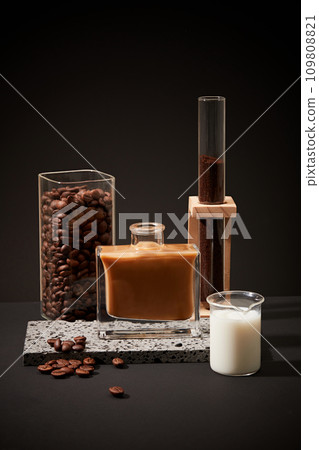 Ingredients for brewing milk coffee showcased against a black backdrop. Consistent consumption of caffeinated coffee is linked to lower risks of diabetes. Copy space. 109808821