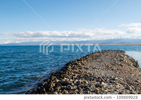 breakwater cape on Issyk-Kul lake at sunny autumn day 109809028