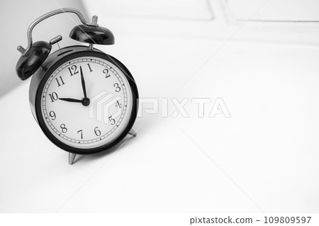 Black retro alarm clock on white background Black retro alarm clock on white background 109809597