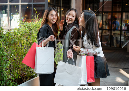 Young happy and attractive three Asian girls are enjoying shopping on the weekend together. 109810036