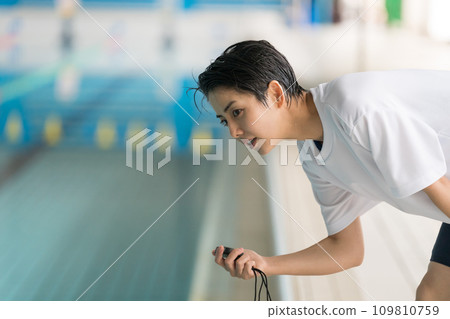 swimming coach and stopwatch swimming coach and stopwatch 109810759