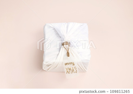 Christmas gift wrapped by traditional Japanese furoshiki style. Handmade gift package for Christmas. 109811265