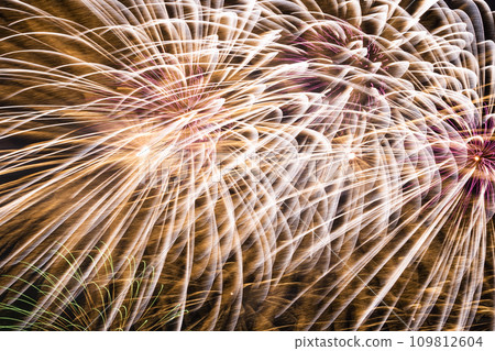 Close-up of colorful fireworks on a black background. 109812604