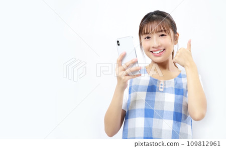Image of a woman operating a smartphone in an apron Image of a woman operating a smartphone in an apron 109812961