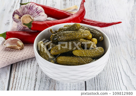 Marinated small cucumbers in the bowl Marinated small cucumbers in the bowl 109812980