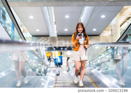 Young asian woman in international airport terminal or modern train station 109813296