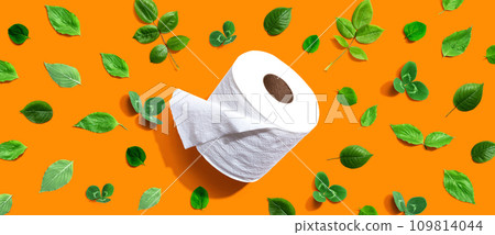 A roll of toilet paper with green leaves 109814044