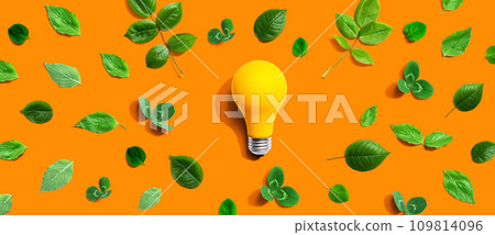 Yellow light bulb with green leaves Yellow light bulb with green leaves 109814096