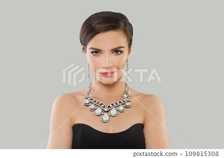 Beautiful jewelry woman brunette fashion model with gold diamond earning and luxury necklace posing Beautiful jewelry woman brunette fashion model with gold diamond earning and luxury necklace posing 109815308