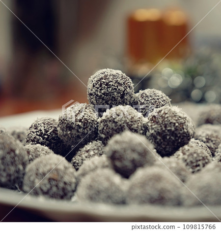 Rum balls in coconut. Traditional unbaked Czech sweets for Christmas and winter. Raw sweet food with cocoa and coconut. Rum balls in coconut. Traditional unbaked Czech sweets for Christmas and winter. Raw sweet food with cocoa and coconut. 109815766