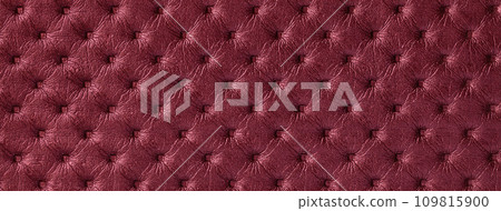 Texture of dark red leather background with capitone pattern, macro. Wine textile of retro Chesterfield style. Texture of dark red leather background with capitone pattern, macro. Wine textile of retro Chesterfield style. 109815900