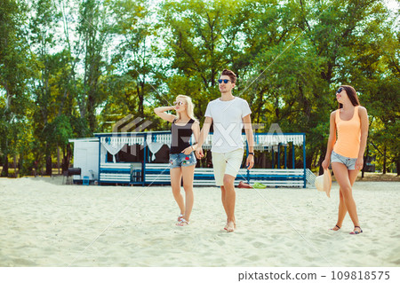 Young funny guys in sunglasses on the beach. Friends together. Young funny guys in sunglasses on the beach. Friends together. 109818575