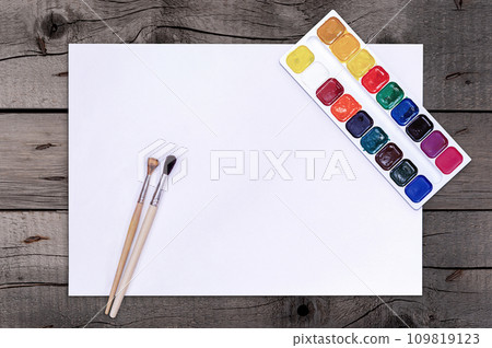 Artist Paint Brushes, Watercolor Palette. Wooden table. Top View. Drawing Tools in Art Studio. File with Clipping Path. Artist Paint Brushes, Watercolor Palette. Wooden table. Top View. Drawing Tools in Art Studio. File with Clipping Path. 109819123