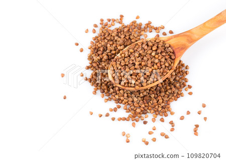 Uncooked buckwheat on wooden spoon Uncooked buckwheat on wooden spoon 109820704