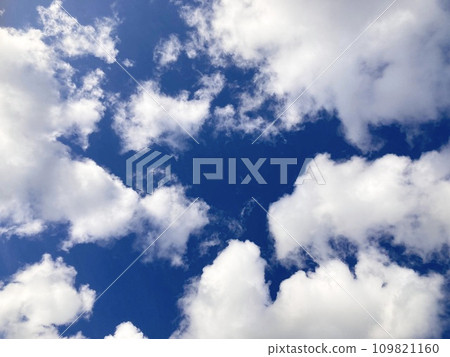 Cotton-like clouds floating in the blue summer sky 109821160