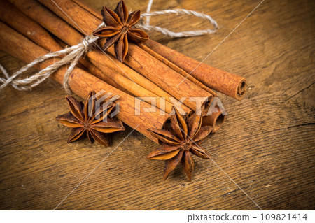 Close up of cinnamon sticks and star anise on wood 109821414