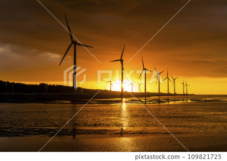 Sunset view of the Gaomei wetlands landscape and the wind power systems in Taichung, Taiwan. energy systems and renewable energy. Sunset view of the Gaomei wetlands landscape and the wind power systems in Taichung, Taiwan. energy systems and renewable energy. 109821725