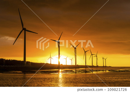 Sunset view of the Gaomei wetlands landscape and the wind power systems in Taichung, Taiwan. energy systems and renewable energy. 109821726